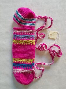 Crocheted torch-cover/carrier made of pre-dyed wool-synthetic mix yarn. Made in Camp 5, Mae Hong Son Province, Thailand and collected by Sandra Dudley in 1997. [Museum number: WA508116]