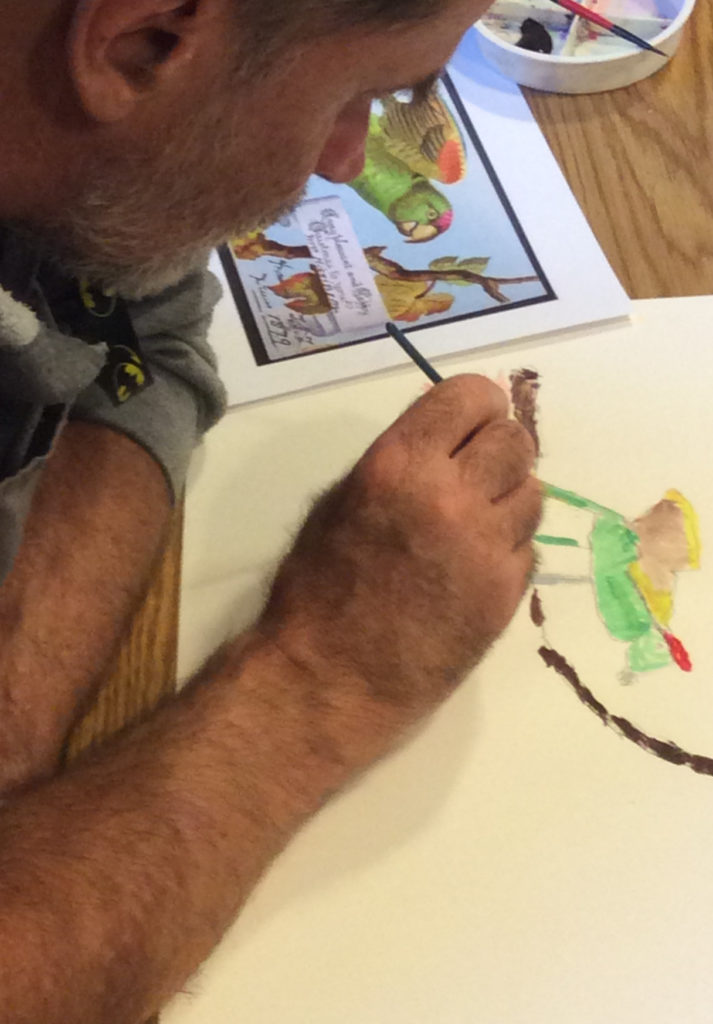 A man paints a picture of a bird