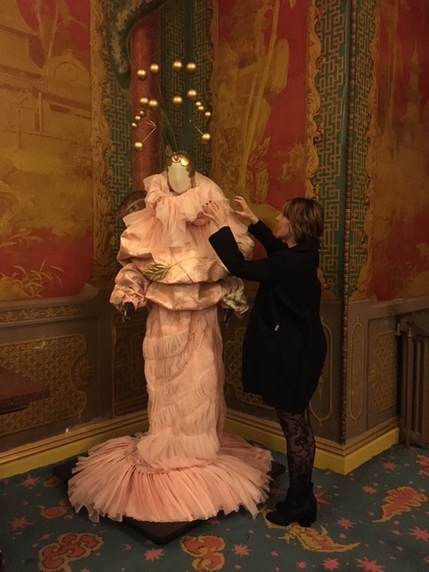 Sue Winkett, Visitor Services Officer works on the Stephen Jones Hats installation.