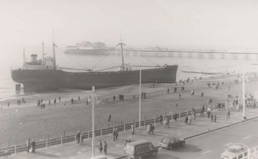 Black and white photo showing ship on Brighton beach
