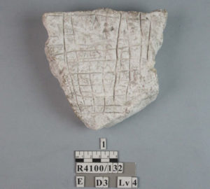 Photo of chalk tablet with label beside it.