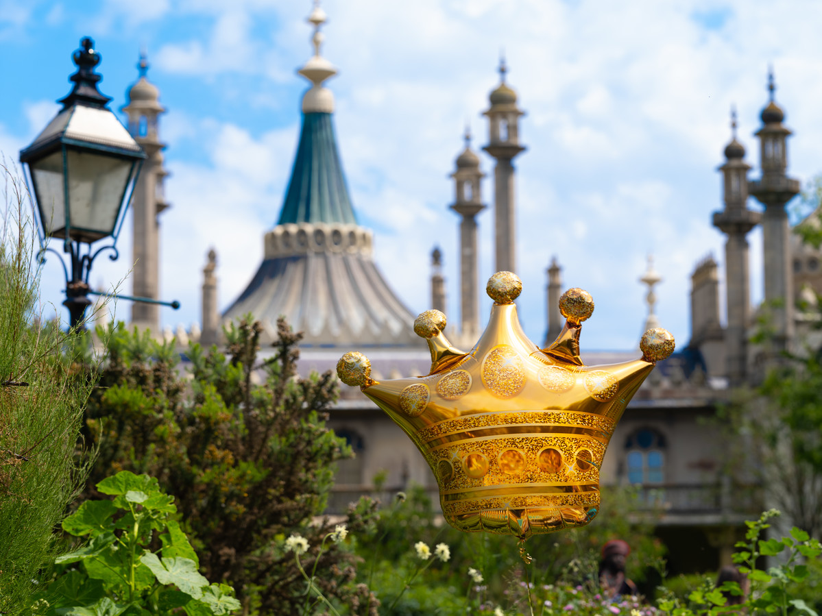View of Royal Pavilion with gold crown-shaped balloon in foreground.