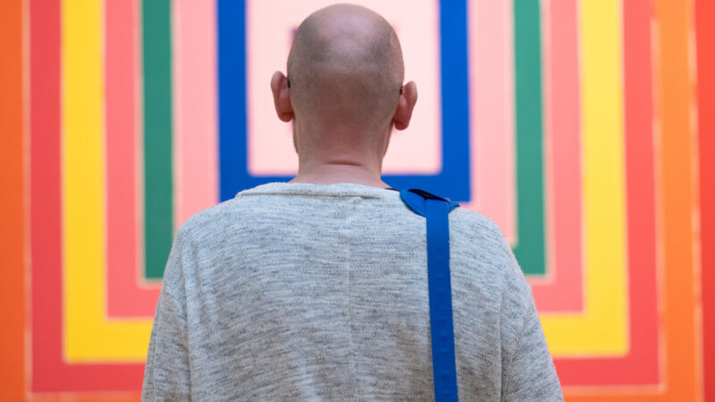 Visitor looking at painting.