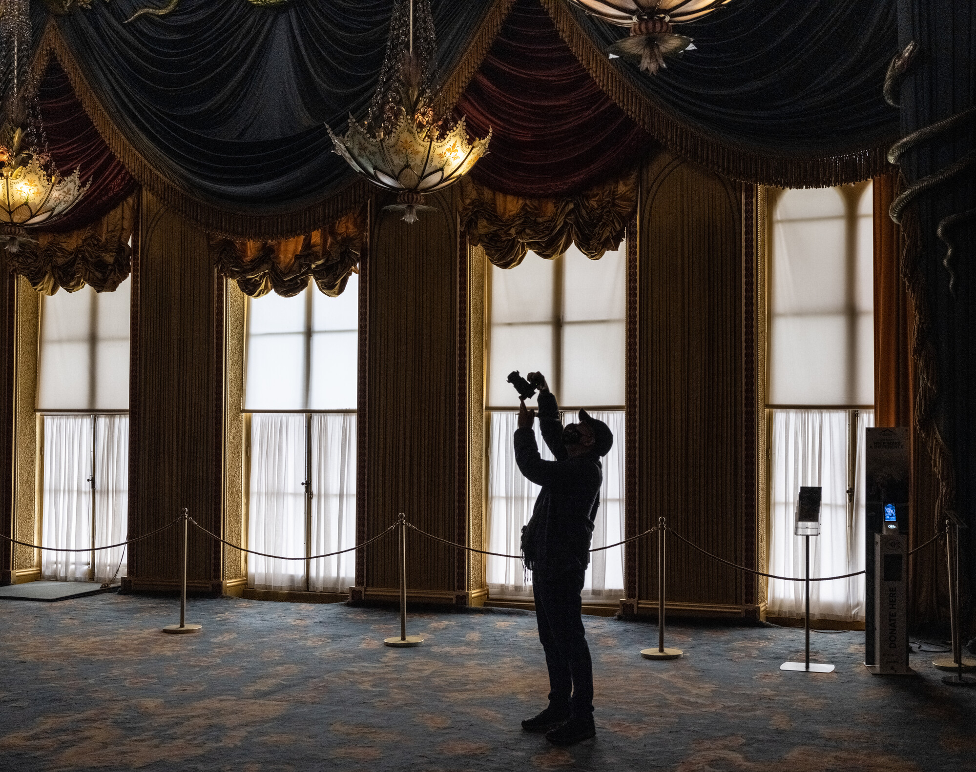 Man taking a photograph in the Music Room of the Royal Pavilion