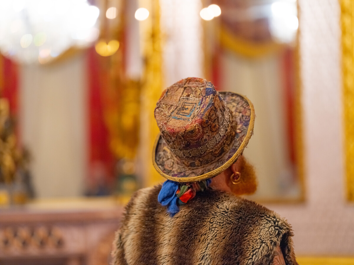 Person wearing a hat looking at highly decorated room.
