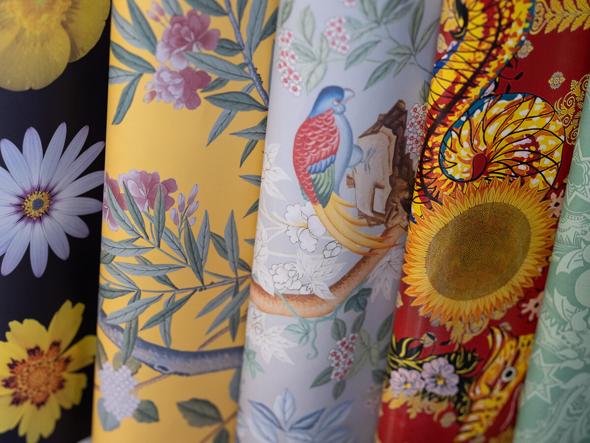 Rolls of brightly coloured wallpaper.