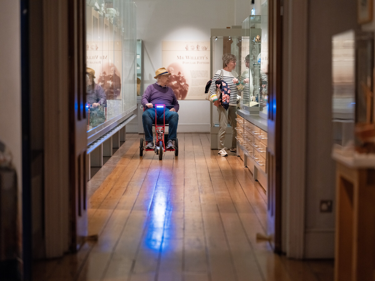 Visitor in wheelchair in gallery.