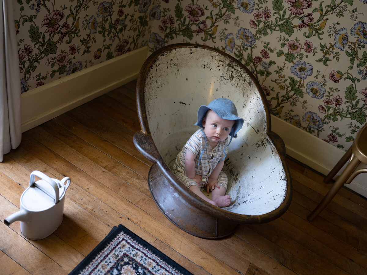 Young child seated in bath tub.