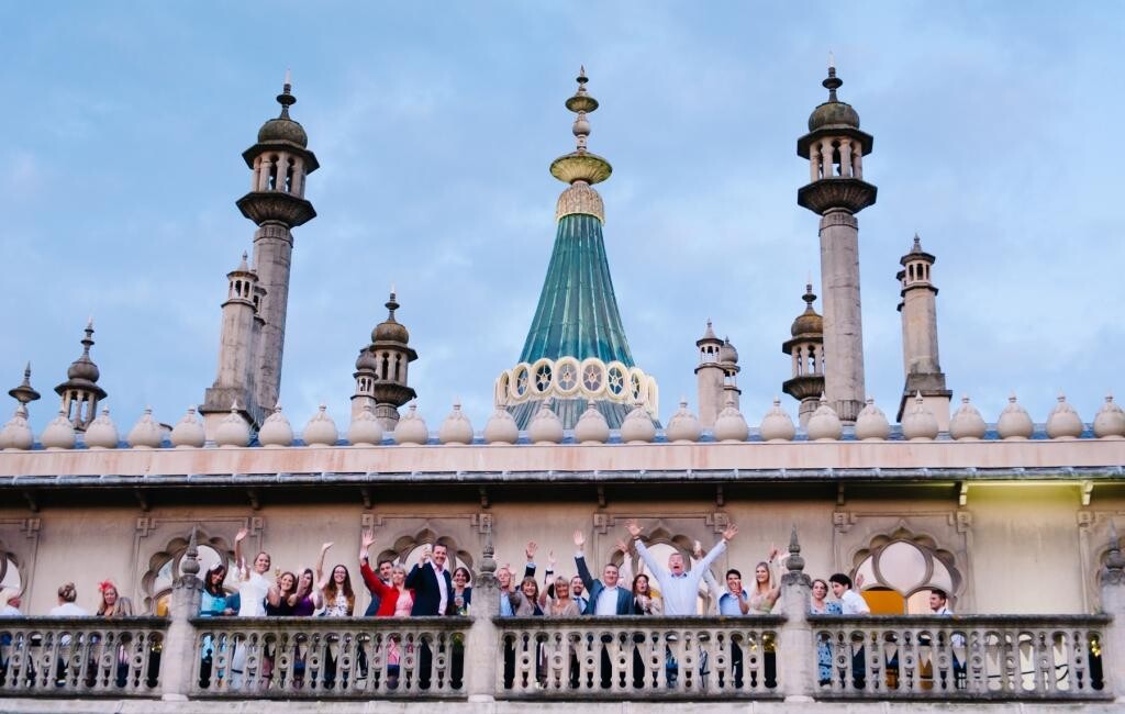 A group of people stand on the balcony of the Royal Pavilion