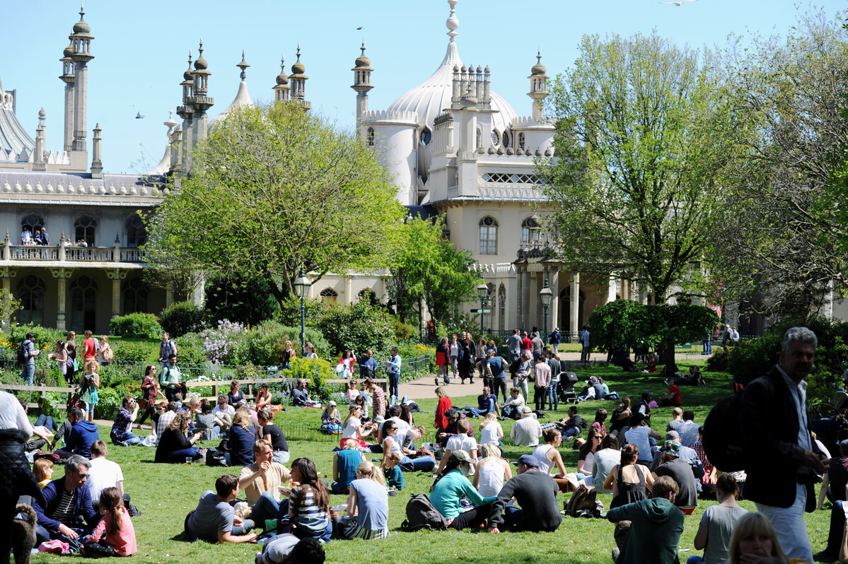 Royal Pavilion Garden with people sitting in the sunshine.