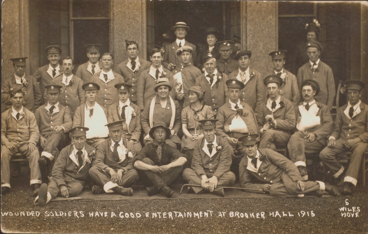 Postcard showing a group of wounded WW1 servicemen outside of Brooker Hall.