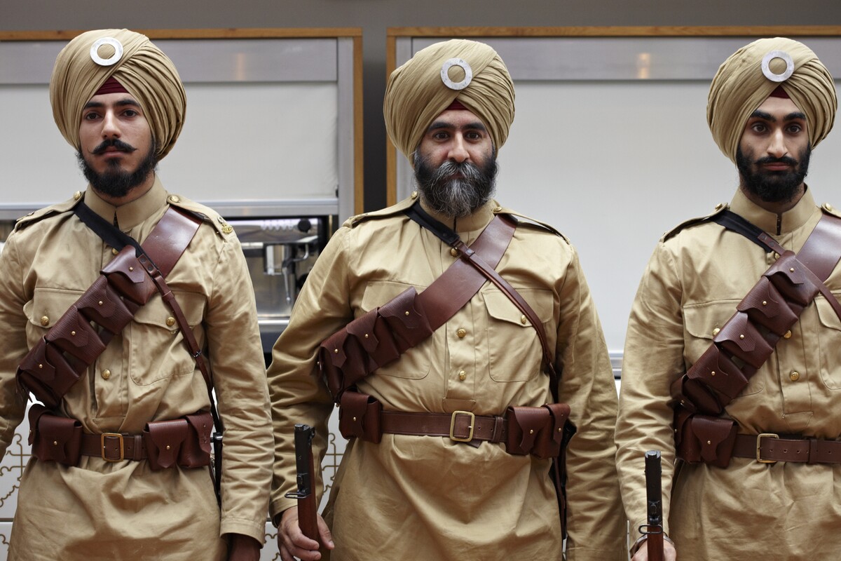Three men dressed as WW1 Sikh soldiers.
