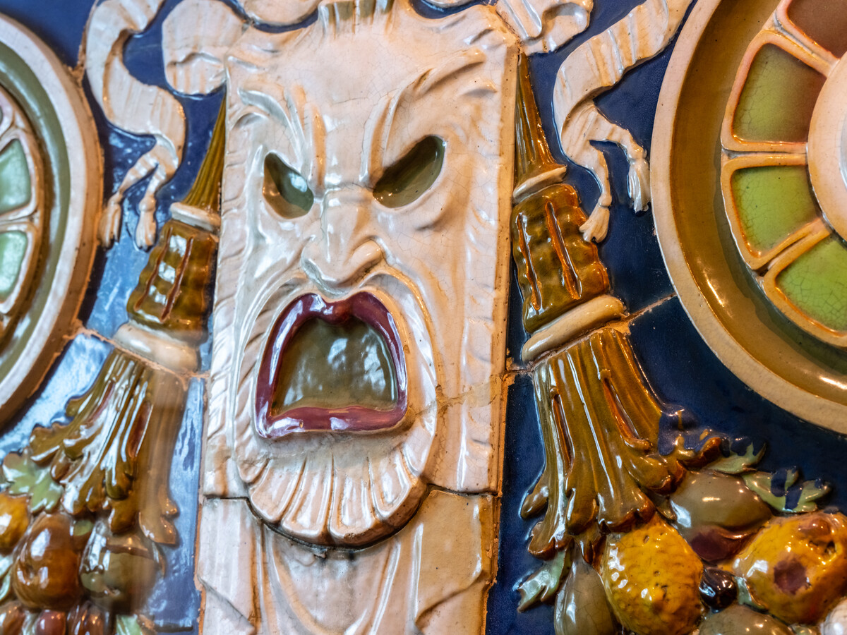 Detail of craft work featuring monstrous face with its mouth open.