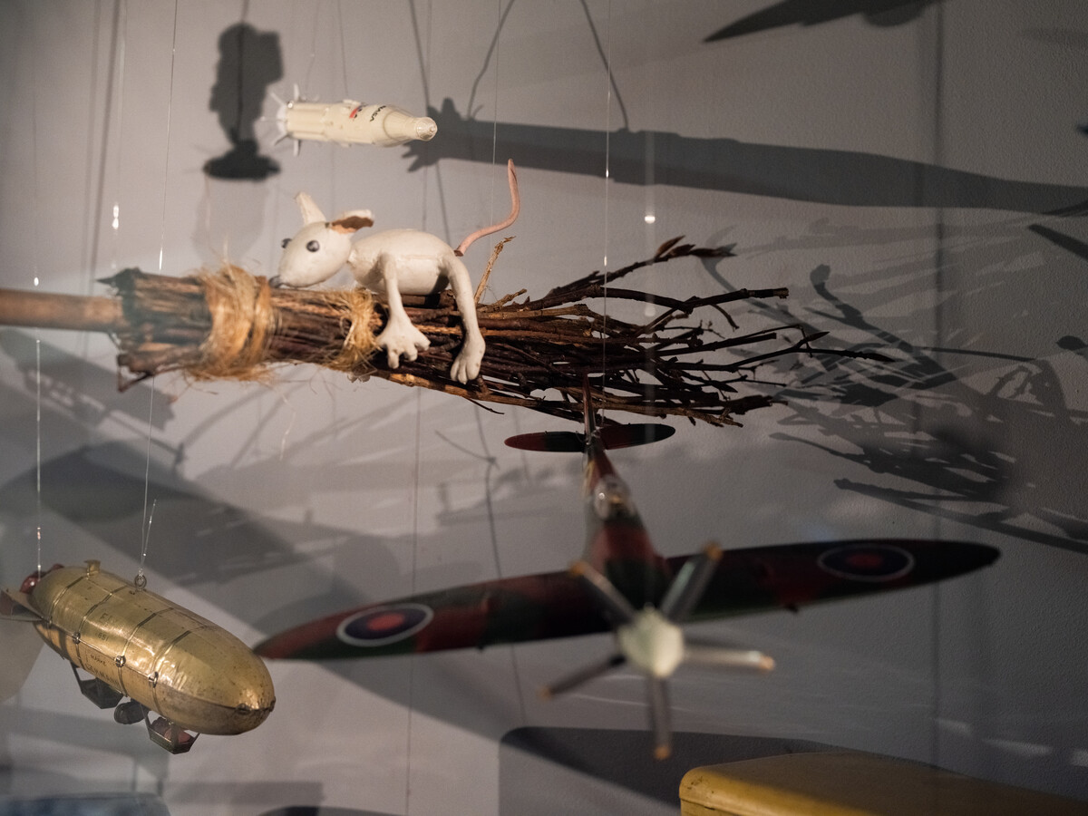 Selection of old flying toys, including model aeroplanes and mouth riding a broomstick.