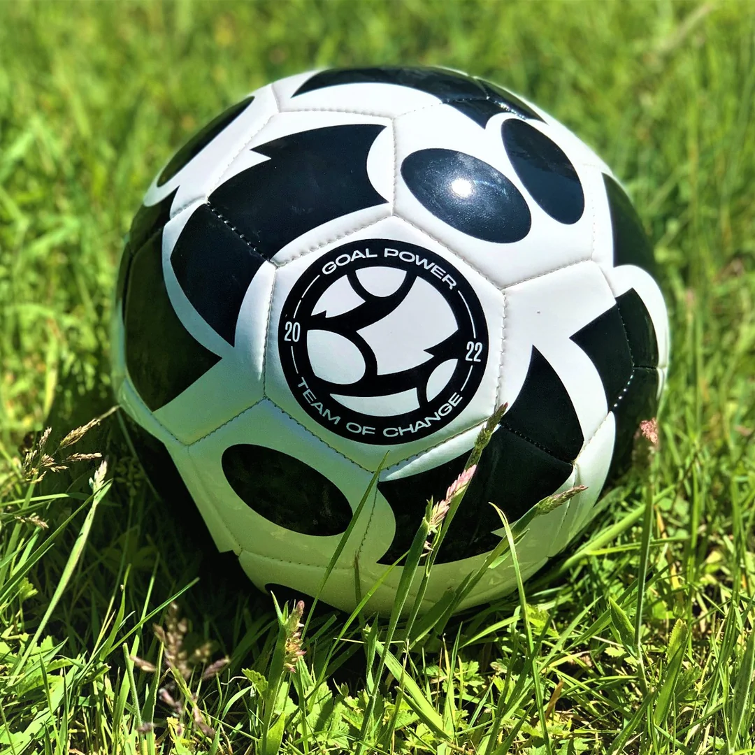 Football with Goal Power logo on grass