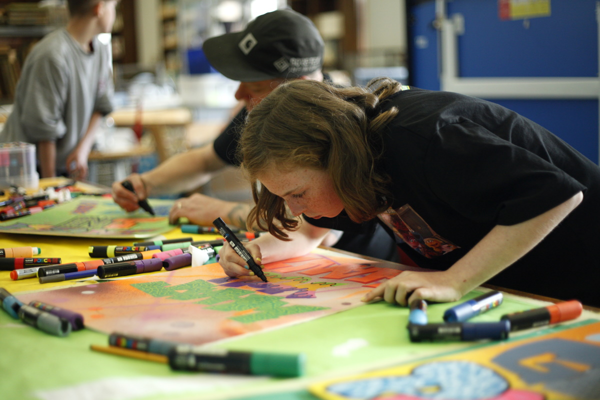 young people creating grafitti signs