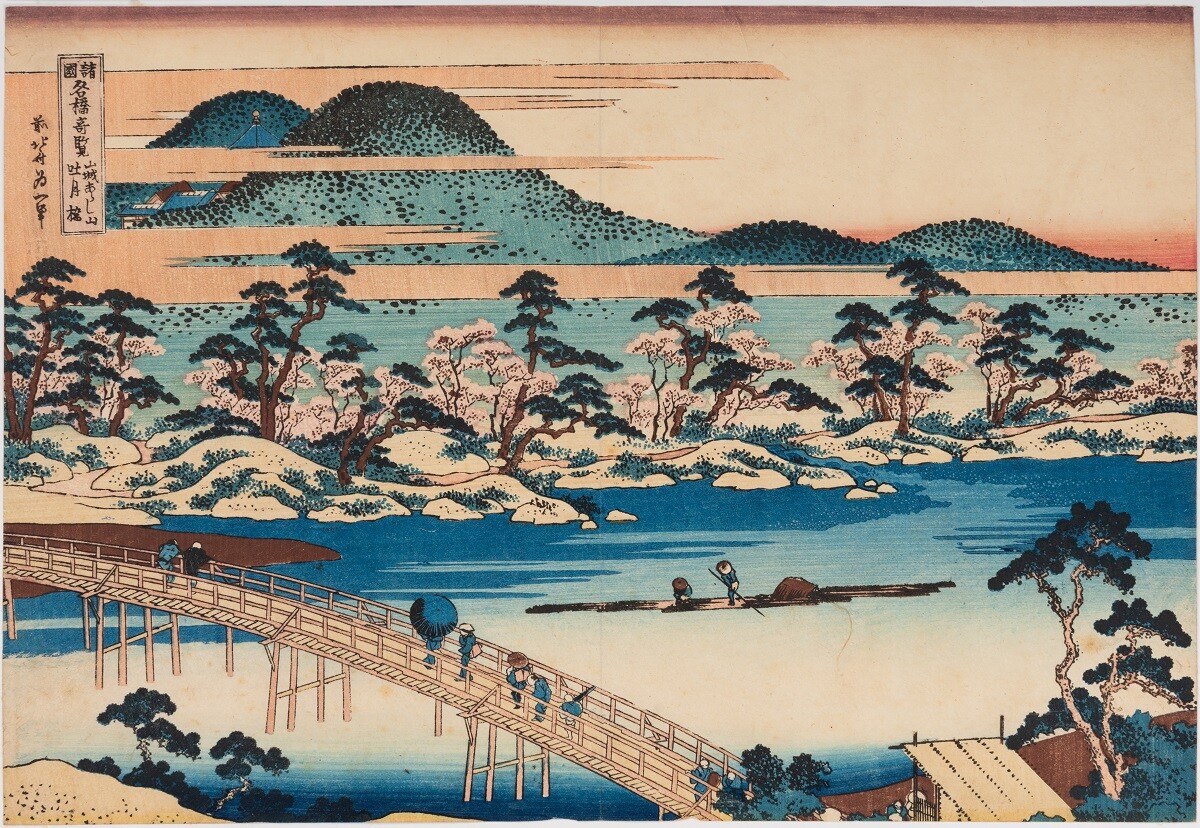 This Japanese woodblock print was created by the great ukiyo-e artist Katsushika Hokusai. It shows a wooden bridge spanning a river, with Arashiyama mountain in the background.