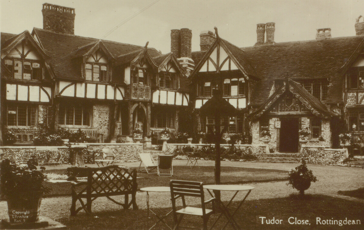 Photographic postcard showing large mock Tudor building.