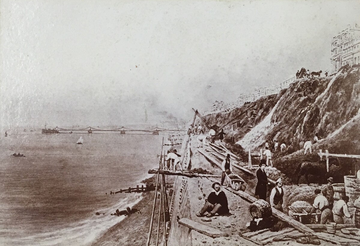 Photographic copy of painting showing construction of a sea wall.