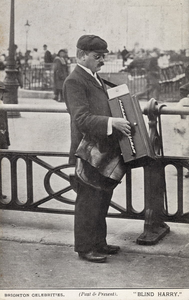 Postcard, c1910 showing the seafront entertainer Blind Harry who plays an accordion on Brighton seafront.