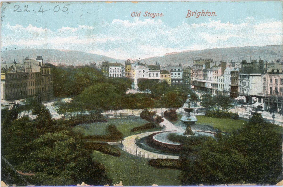 Postcard of the Old Steyne. Brighton. a large fountain is in teh centre, surrounded by grass and trees. Buildings are seen beyond.