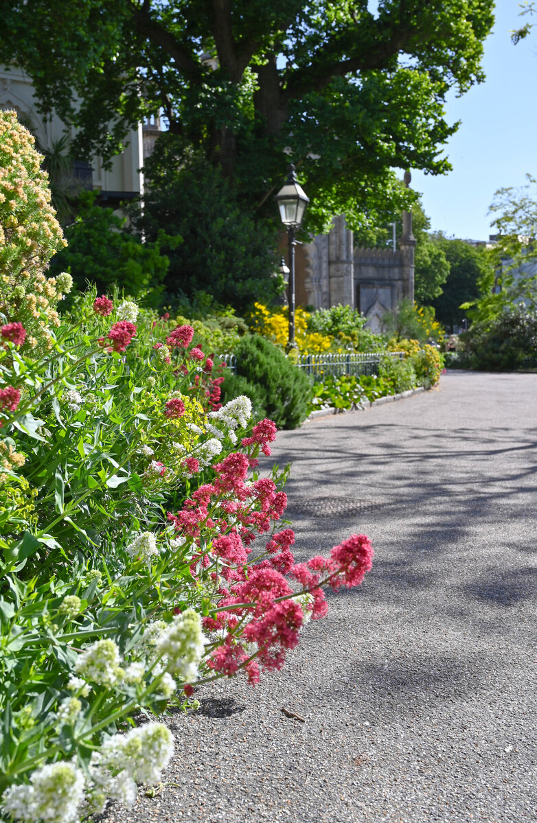 Royal Pavilion and Garden, blooming flowerbeds can be seen to the left, a path to the right