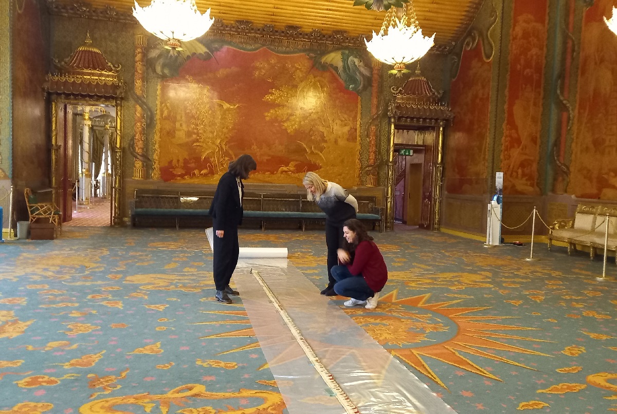 The first complete unrolling, in the Music Room of the Royal Pavilion, with Paper Conservator Amy Junker Heslip.