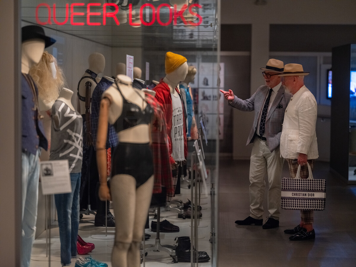 Two men visit the Queer Looks exhibition in Brighton Museum & Art Gallery