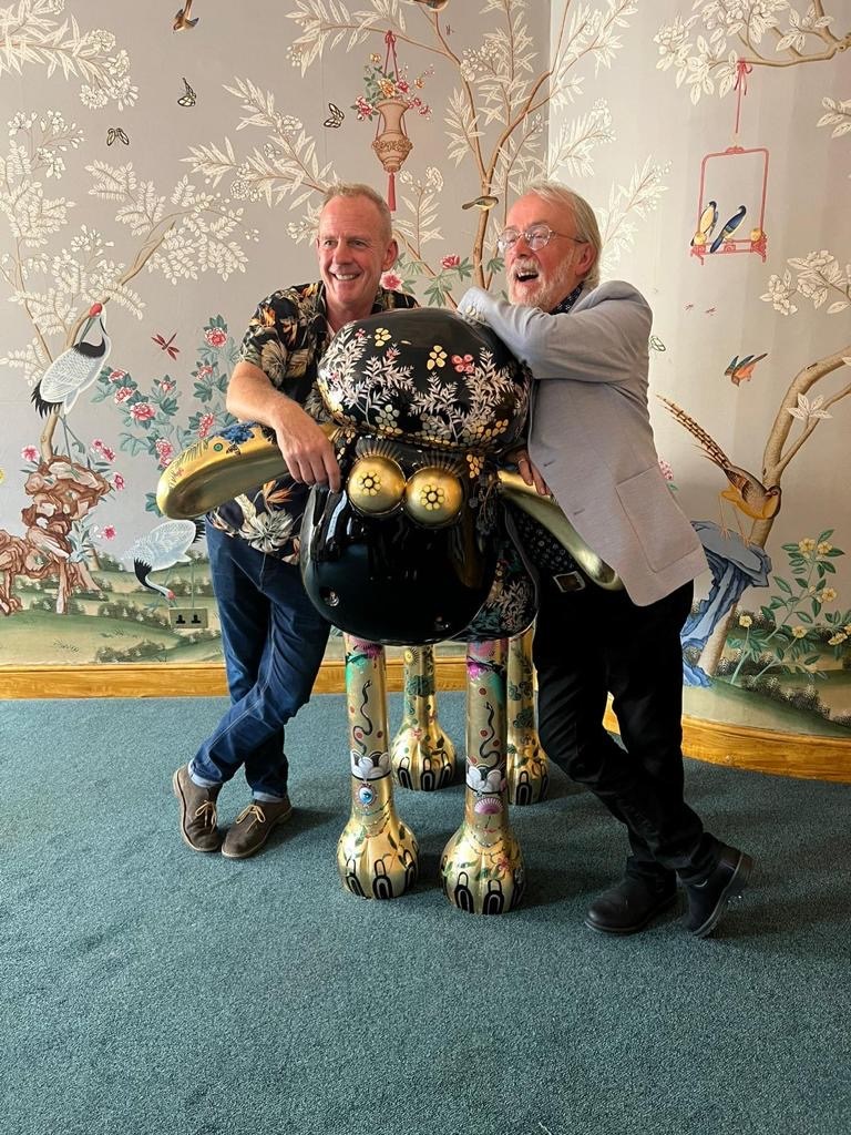 Fatboy Slim and Peter Lord pose next to Regency Shaun in the Royal Pavilion