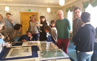 Delegates inspecting wallpaper fragments from the Royal Pavilion archives