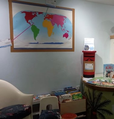 Holiday postcards and decolonised map on the wall at the Booth Museum