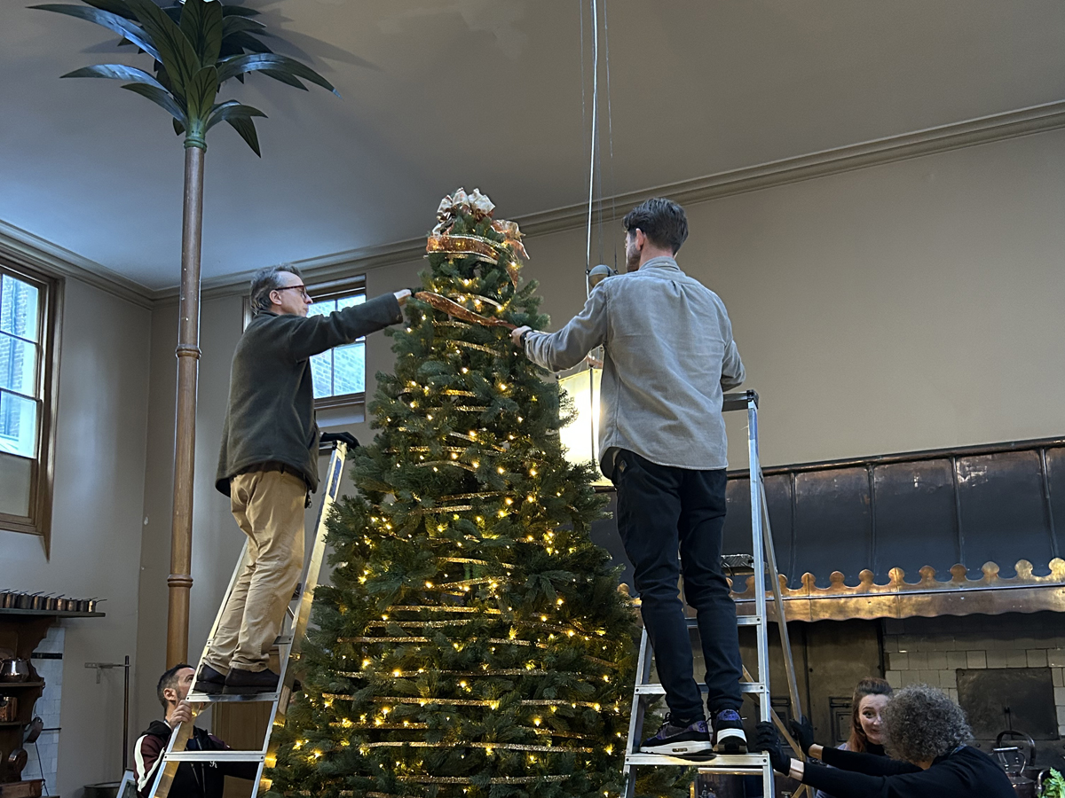 Installing the Christmas tree in the Great Kitchen of the Royal Pavilion