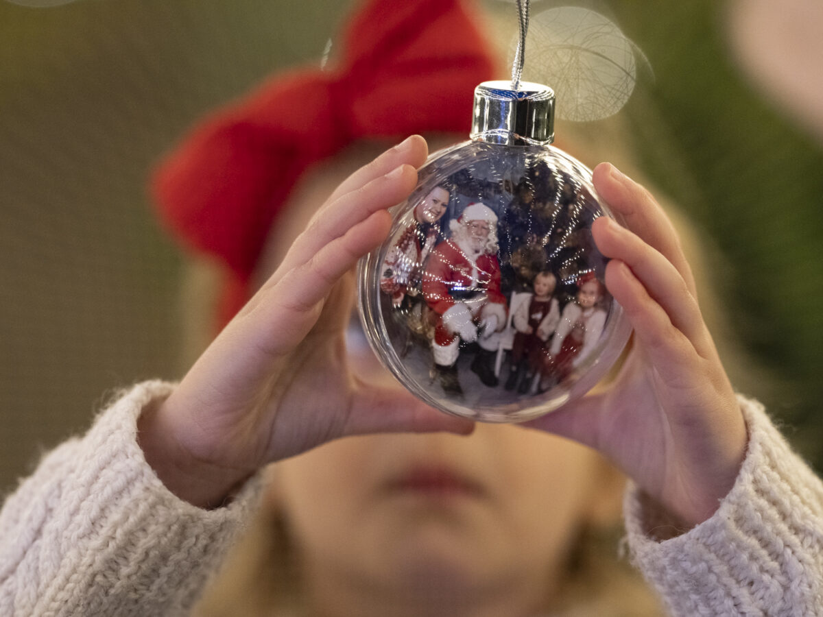 Little girl is holding a Christmas bauble
