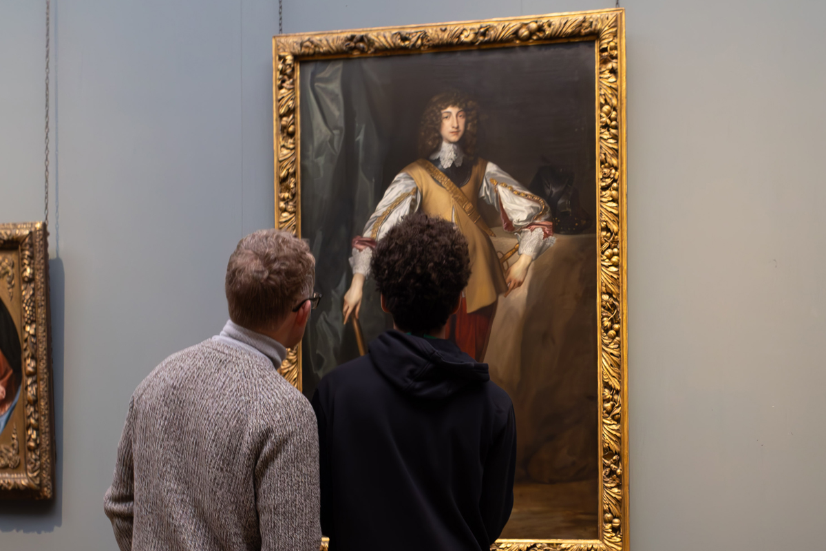 Photography Club's visit to the National Gallery. A man and a teenage boy stand in front of a painting, they look to be discussing the work.