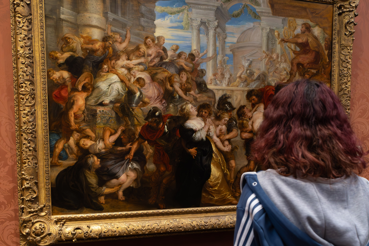 Photography Club's visit to the National Gallery. A girl stands looking at a painting in a gallery.