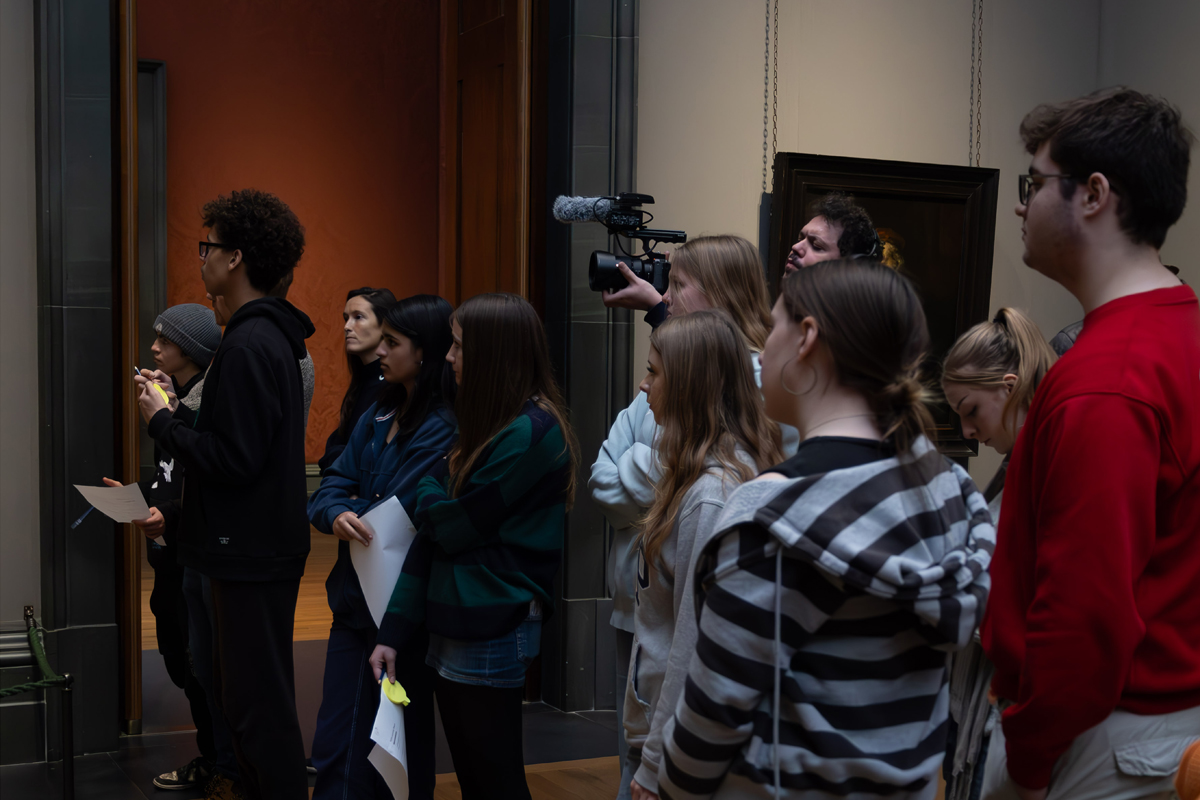 Photography Club's visit to the National Gallery. The club stands in a gallery all looking towards paintings on the left.