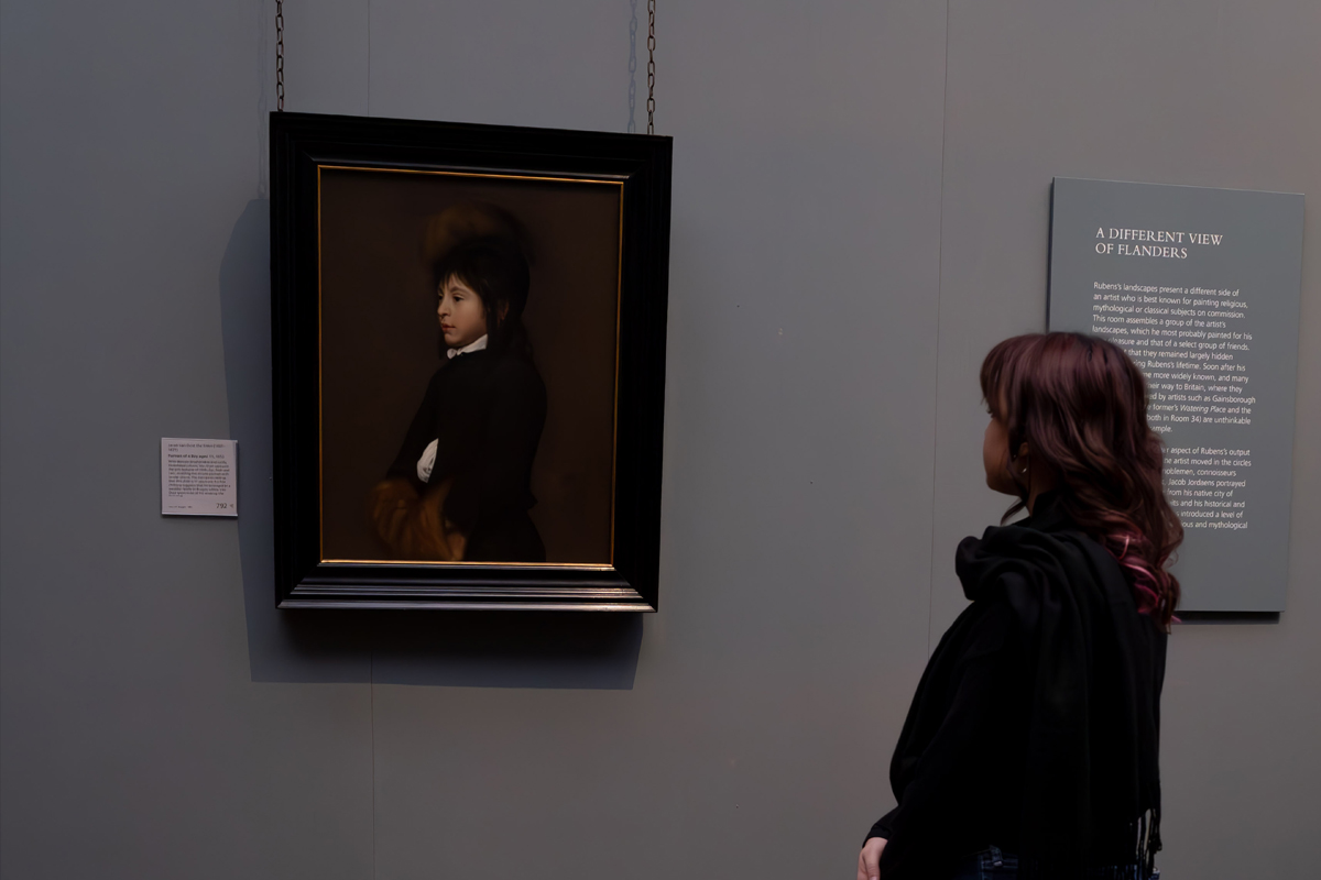 Photography Club's visit to the National Gallery. A girl stands to the right looking at a portrait in a gallery