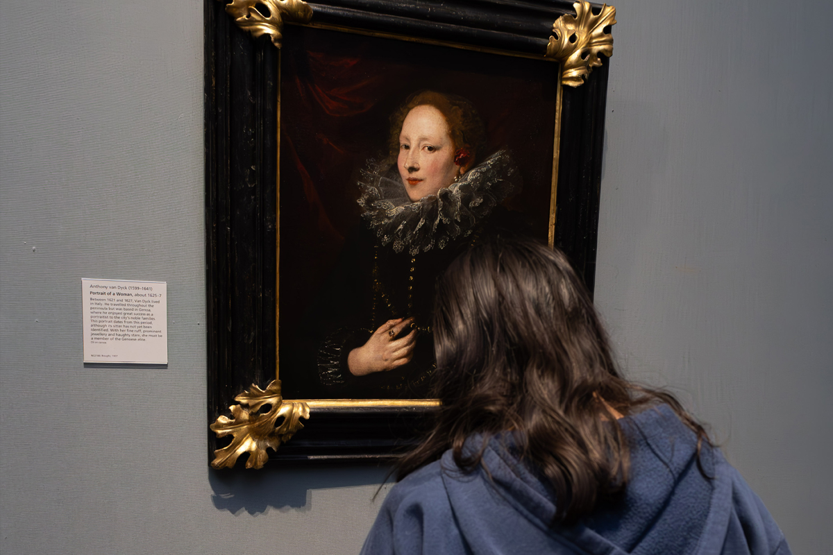 Photography Club's visit to the National Gallery. A girl stands looking at a portrait of a woman with