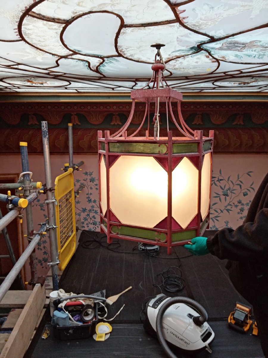 Conservation work on the lights in the Royal Pavilion by the Bamboo Staircase