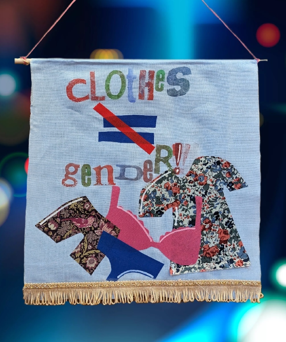 Banner for Pride, decorated with images of clothing it says Clothes = (with a slash over ) Gender
