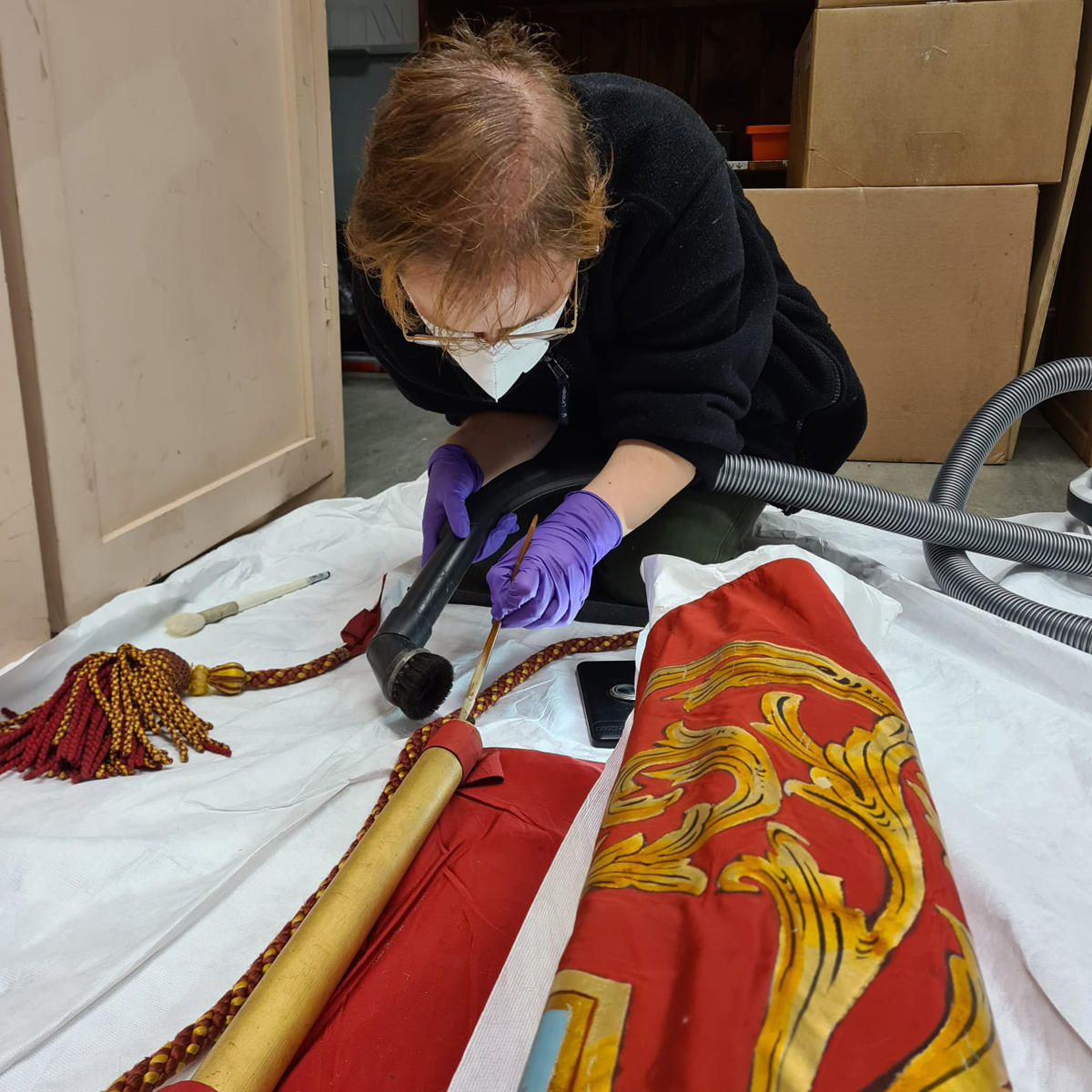 Tessa cleaning a banner