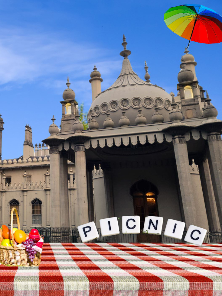 Pre Pride picnic event at the Royal Pavilion for COLOUR. A picnic blanket and a rainbow umbrella and food baskets are displayed outside the Royal Pavilion