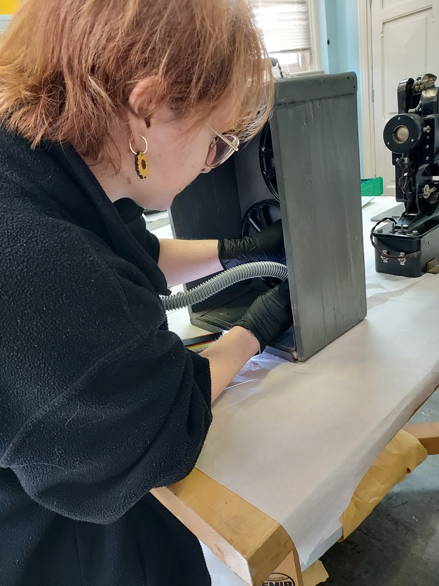 Myself cleaning a projector case of dust. No mould was found on this item