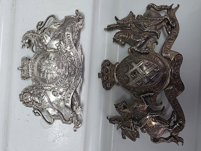 Serving tray crests – one uncleaned, the other cleaned with Silver Dip