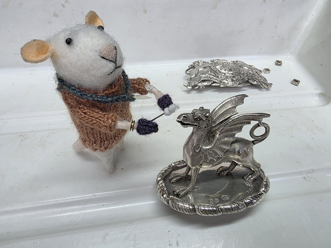 Team mascot ConservRator helps clean part of a serving tray