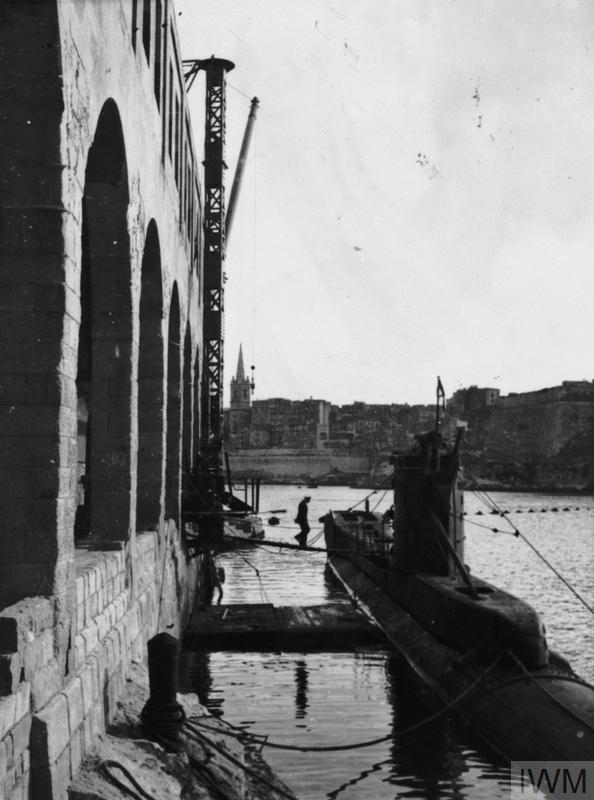 HMSM UNBEATEN (FL 20409) Moored alongside a dock in Malta. Copyright: © IWM. Original Source: http://www.iwm.org.uk/collections/item/object/205121581