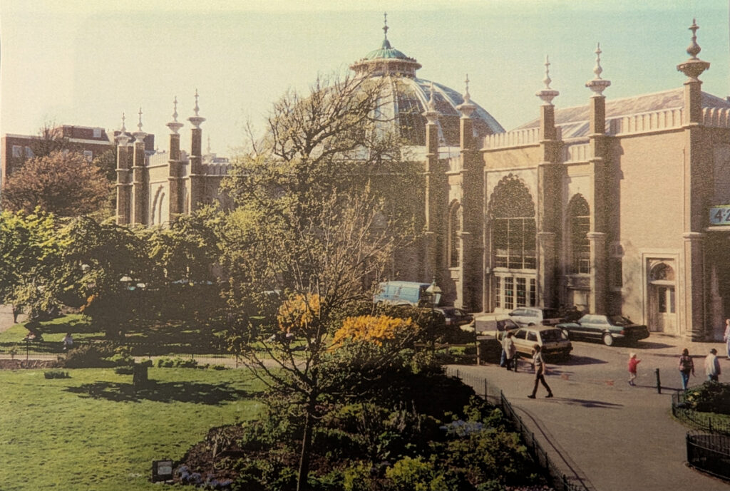 Royal Pavilion Garden, May 1996. The Dome and the side of Brighton Museum are visible in the background. People can be seen walking on the paths around the garden.