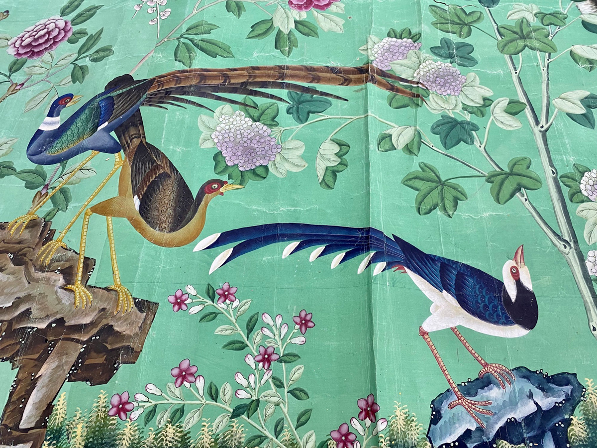 Hand painted historic wallpaper from the Royal Pavilion. An elaborate bird and flowers design against a light green background