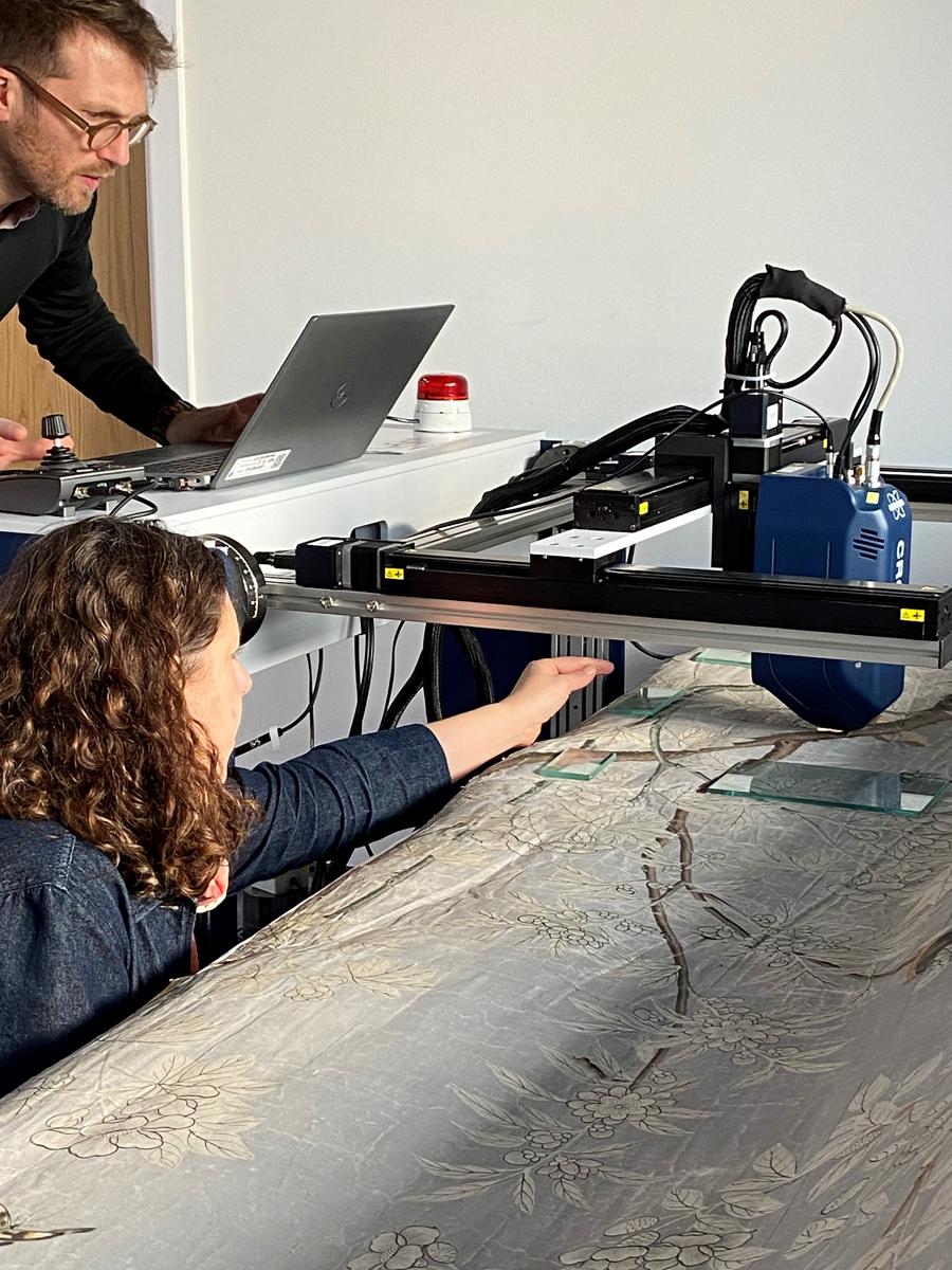 Paper conservator Amy Junker Heslip working with the Chinese wallpaper.