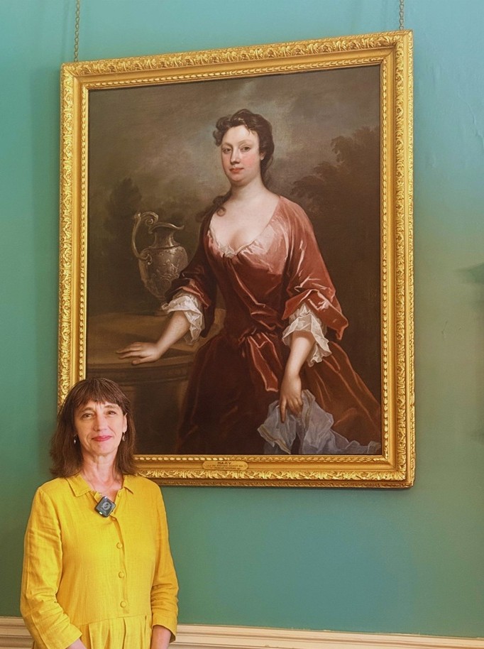 Curator Alexandra Loske stands in front of Mary Western portrait at Preston Manor